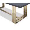 Black grain dining table with sturdy yet delicate polished brass-finished stainless steel legs