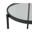 Black round side table with glass top and lower shelf