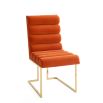 A luxury dining chair by Jonathan Adler with a polished brass base and 70s style red ribbed design