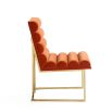 A luxury dining chair by Jonathan Adler with a polished brass base and 70s style red ribbed design