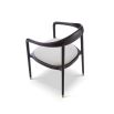 rounded black minimalist dining chair with brass caps on the feet and boucle seat