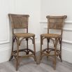 wood and rattan barchair with arching shapes in base