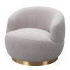 Small and circular boucle taupe swivel chair with rounded edges and brass base