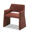 Rust dining chair with large tapered legs and wrap-around back