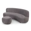 A sumptuous sofa by Liang & Eimil with a curved design and luxury grey velvet upholstery