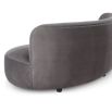 A sumptuous sofa by Liang & Eimil with a curved design and luxury grey velvet upholstery