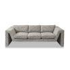 A stylish sofa by Liang & Eimil with an abstract shape and grey patterned upholstery