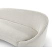 A contemporary curved sofa by Liang & Eimil with a beautiful boucle upholstery