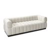 A contemporary sofa with a boucle upholstery and deep channel stitching design