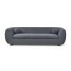 A contemporary sofa with two ball scatter cushions and a dark grey upholstery