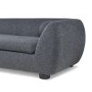 A contemporary sofa with two ball scatter cushions and a dark grey upholstery