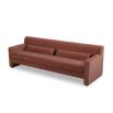 A modern sofa with a statement rust upholstery and scatter cushions