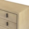 Light brown textured chest of drawers with dark frame and dark handles