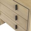 Light brown textured chest of drawers with dark frame and dark handles