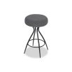 Grey upholstered round seated counter stool with boldly splayed open hourglass base with gentle tapering.