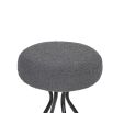 Grey upholstered round seated counter stool with boldly splayed open hourglass base with gentle tapering.