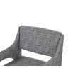 Elegant upholstered chair with arched supports and a complete fabric wrap in grey