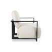 Cream upholstered armchair with angular black arms