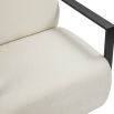 Cream upholstered armchair with angular black arms