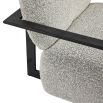 Grey boucle upholstered armchair with angular black arms