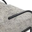 Speckled grey upholstered accent chair with rounded back and seat with black minimal arms