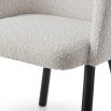 Boucle dining chair with wrap-around backrest and tapered legs