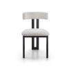 Elegant three-legged dining chair with boucle back rest and seat