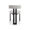 Elegant three-legged dining chair with boucle back rest and seat