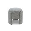 Small round stool upholstered in speckle grey fabric with wide legs overlapping the seat