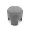 Small round stool upholstered in speckle grey fabric with wide legs overlapping the seat