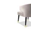 A luxury dining chair by Liang & Eimil with a sophisticated grey upholstery