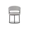 Curved back dining chair in grey velvet with black base frame