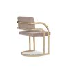 Beige velvet dining chair with art deco inspired arched arms in brass