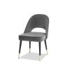 Dark grey velvet upholstered dining chair with arch detail black legs and brass cap feet 