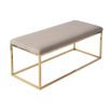 A luxury bench by Liang & Eimil with a polished brass finish and velvet upholstery