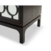 A statement bedside table by Liang & Eimil with a glass and dark wood finish