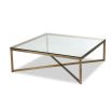 Brass frame coffee table supporting clear glass top