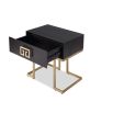 Black wood side table with geometric brass details