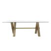 Artisan-crafted dining table with brass legs topped with an expanse of toughened clear glass