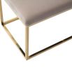 A luxury bench by Liang & Eimil with a polished brass finish and velvet upholstery