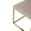 A luxury bench by Liang & Eimil with a polished brass finish and velvet upholstery