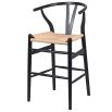 Black barstool with natural rattan seat