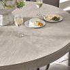 Round grey washed wood dining table with minimal base