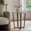 Round side table with a green marble top and a brass frame