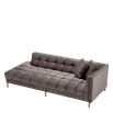 Grey velvet corner sofa with brass finish accents