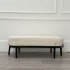 An elegant bench by Eichholtz with a luxury bouclé cream upholstery and beautiful black finished frame