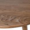 three-legged round wooden dining table