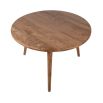 three-legged round wooden dining table