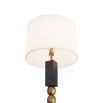 Floor lamp with blocks of ebonised mango wood that border a totem of antique brass spheres