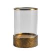 Lantern with textured brass base and cylindrical glass frame